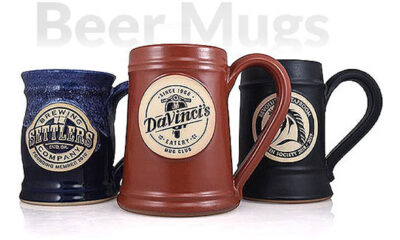 Group of three handmade custom beer steins with logos.